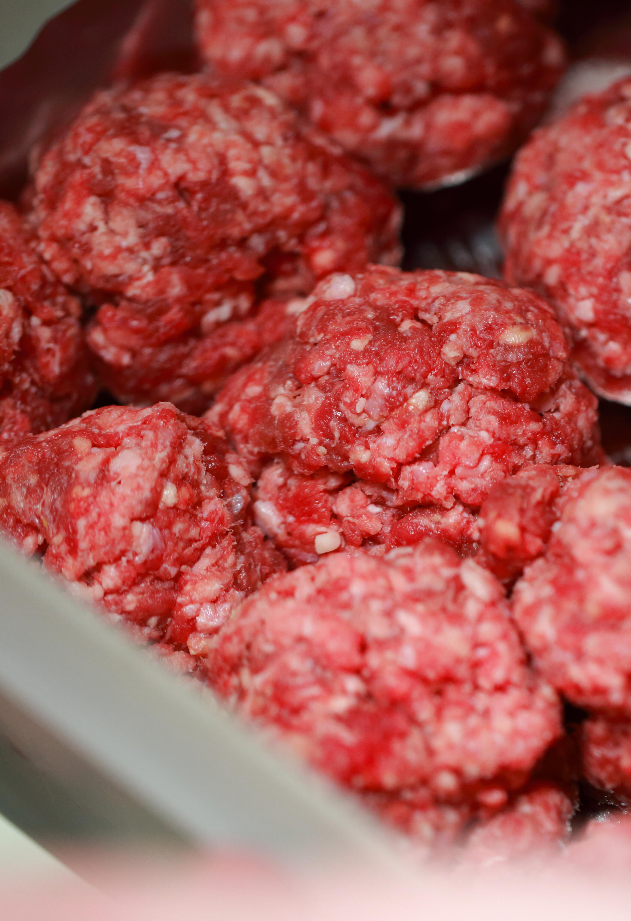 Fresh meatballs Minimal egg carton with one brown egg among white eggs on bright white background